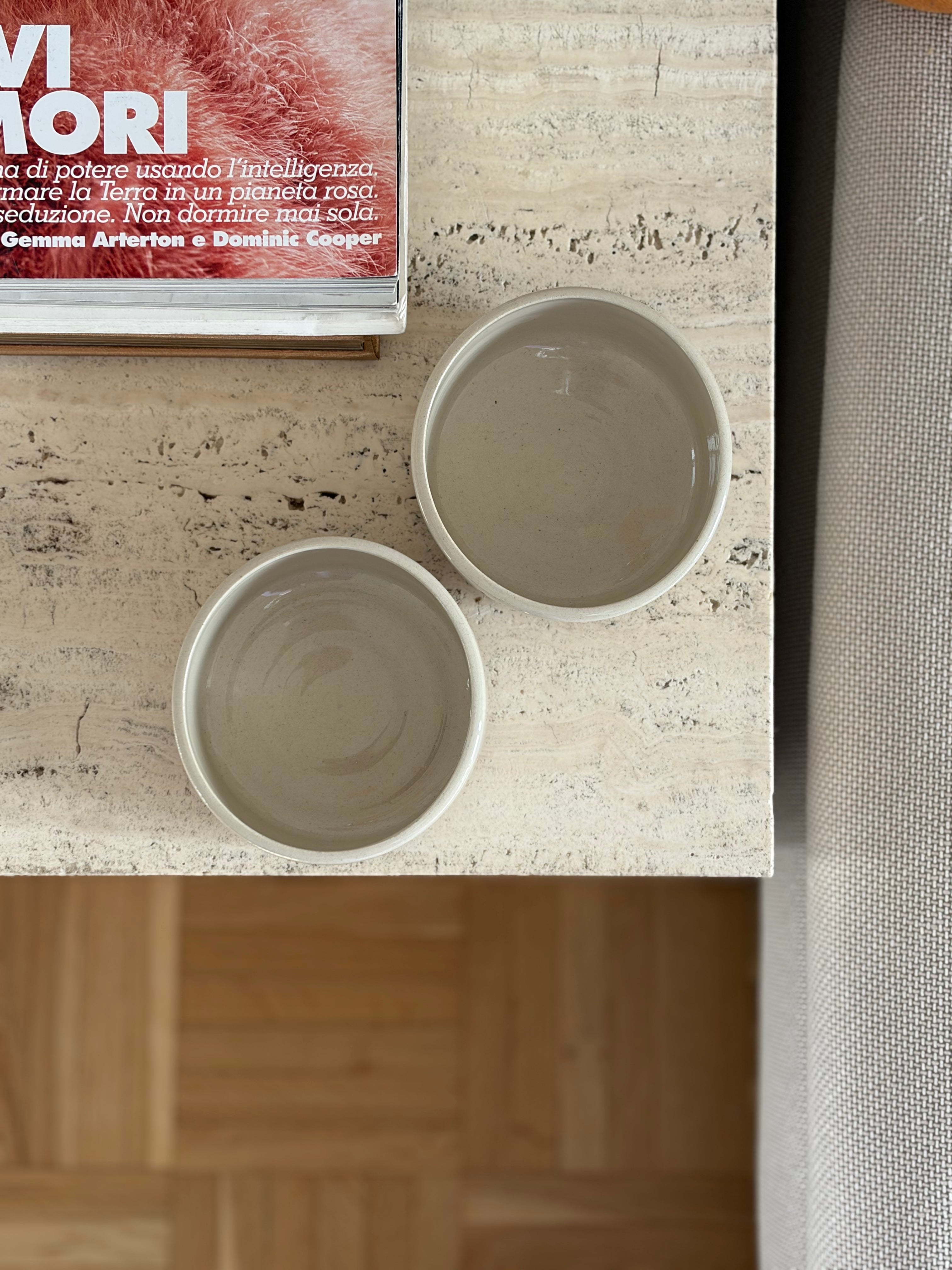 2 beige Keramikbecher auf einem Marmortisch von oben fotografiert. 